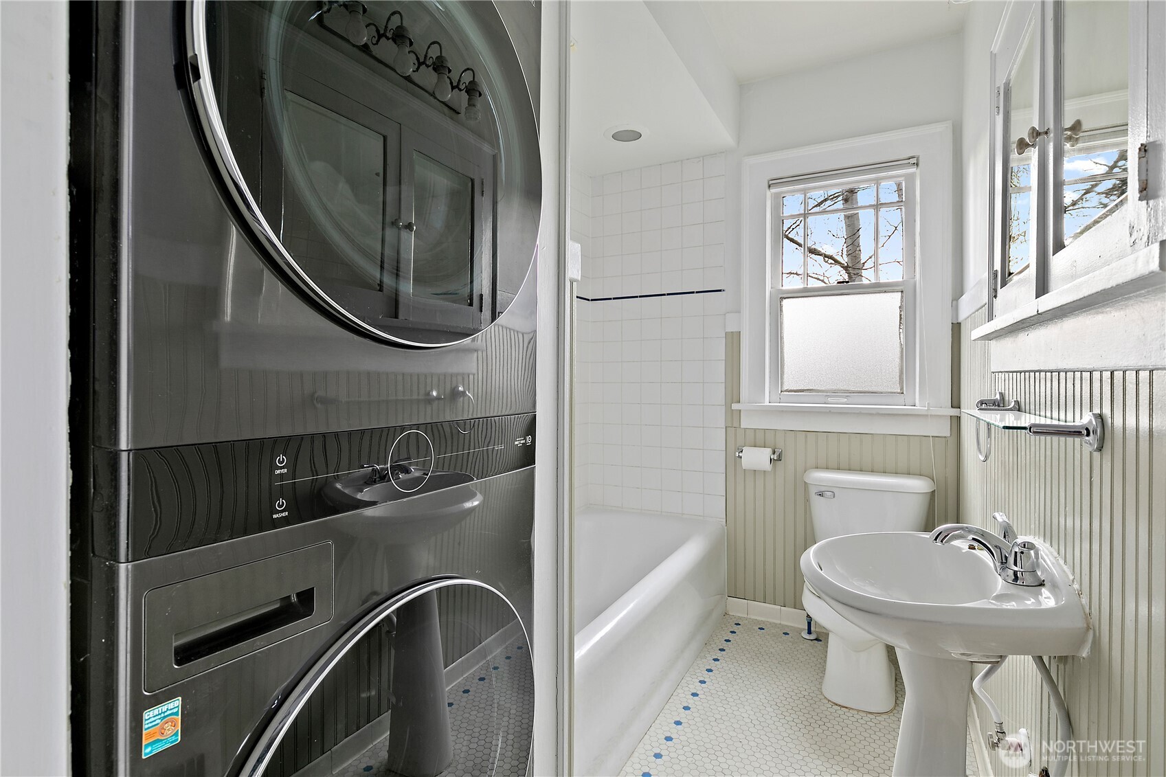 1125 North 77th Street Seattle, WA 98103 - Photo 14 of 38 a bathroom with a sink a toilet and a mirror