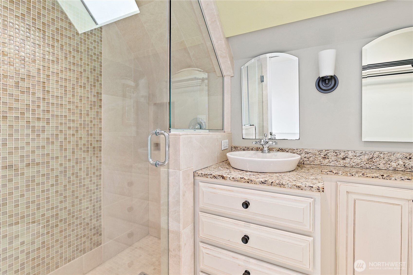 1125 North 77th Street Seattle, WA 98103 - Photo 19 of 38 a bathroom with a granite countertop sink and a mirror