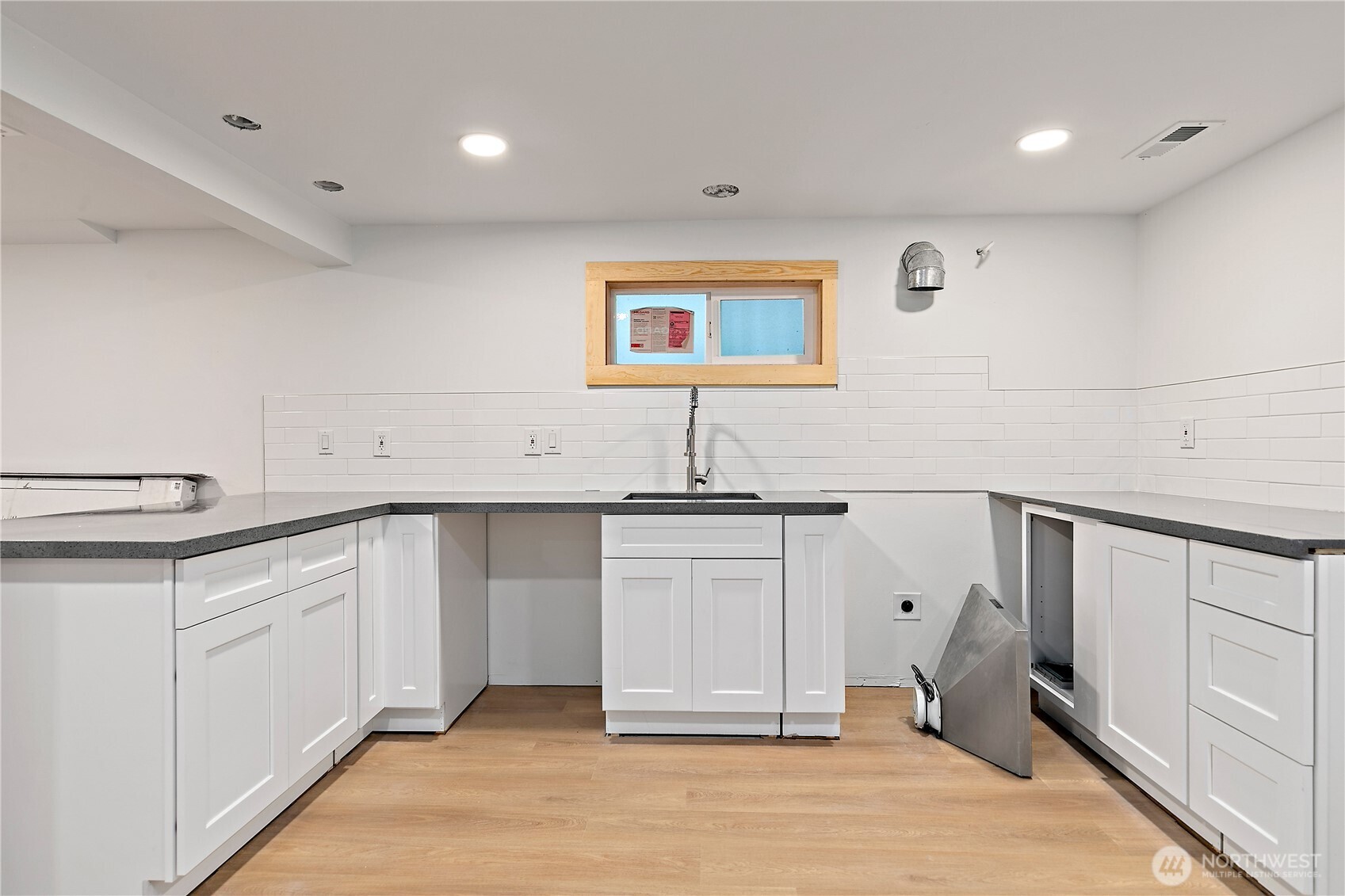 1125 North 77th Street Seattle, WA 98103 - Photo 23 of 38 a kitchen with granite countertop a sink and cabinets