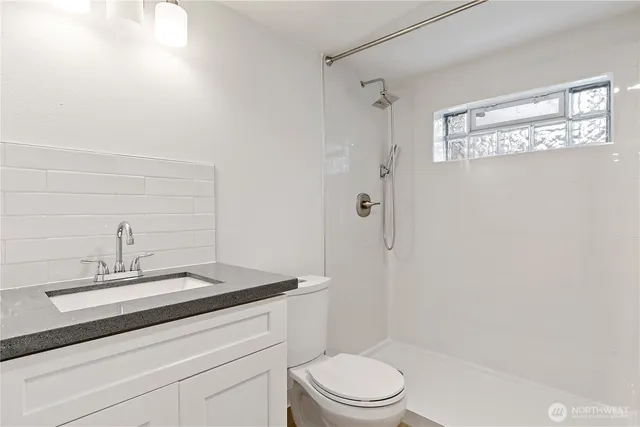 an empty room with wooden floor and white walls