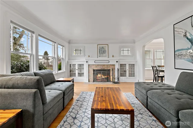 a living room with furniture a fireplace and a window