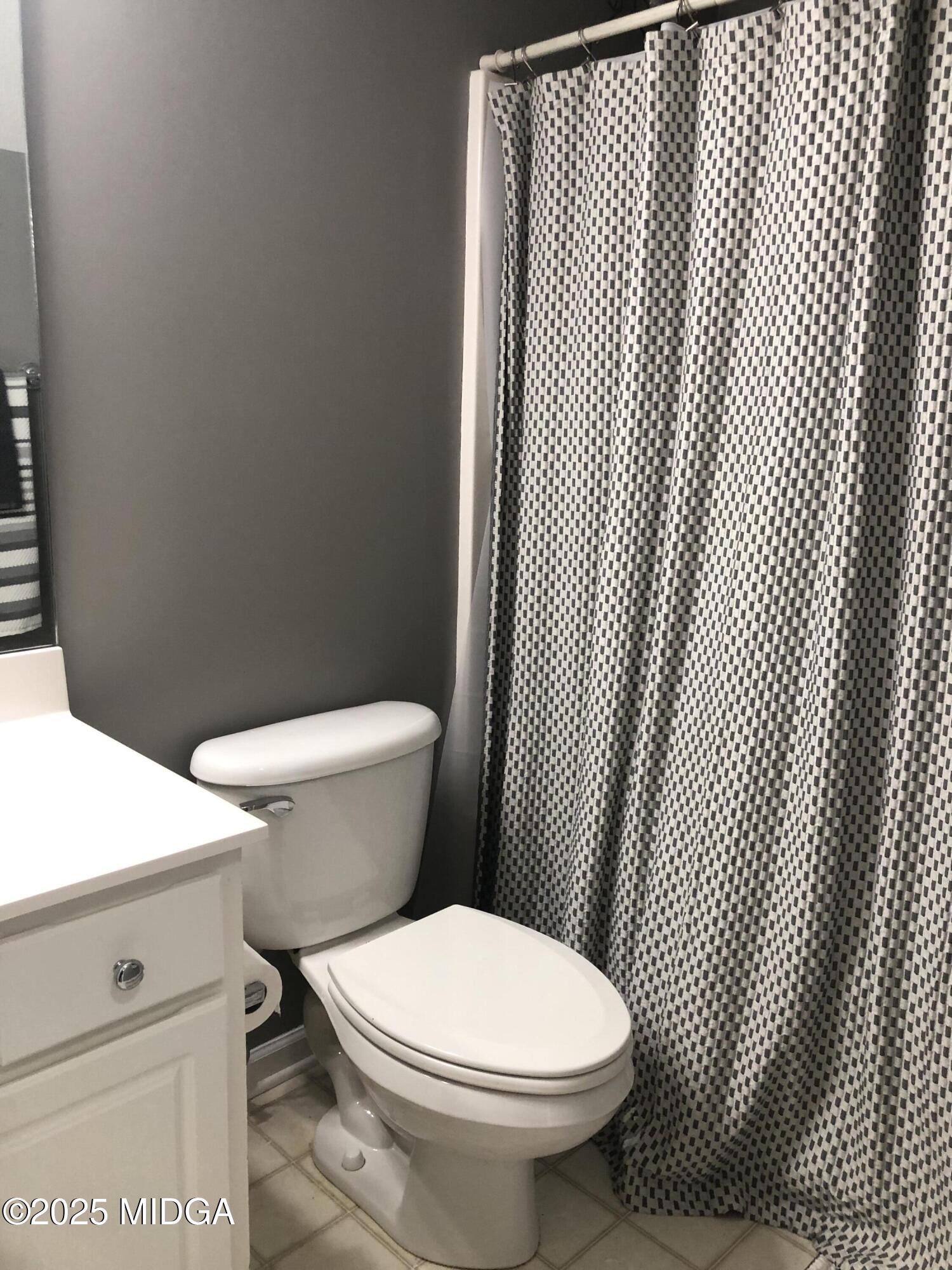 630 Millrun Court Macon, GA 31210 - Photo 16 of 23 a white toilet sitting next to a bathroom sink