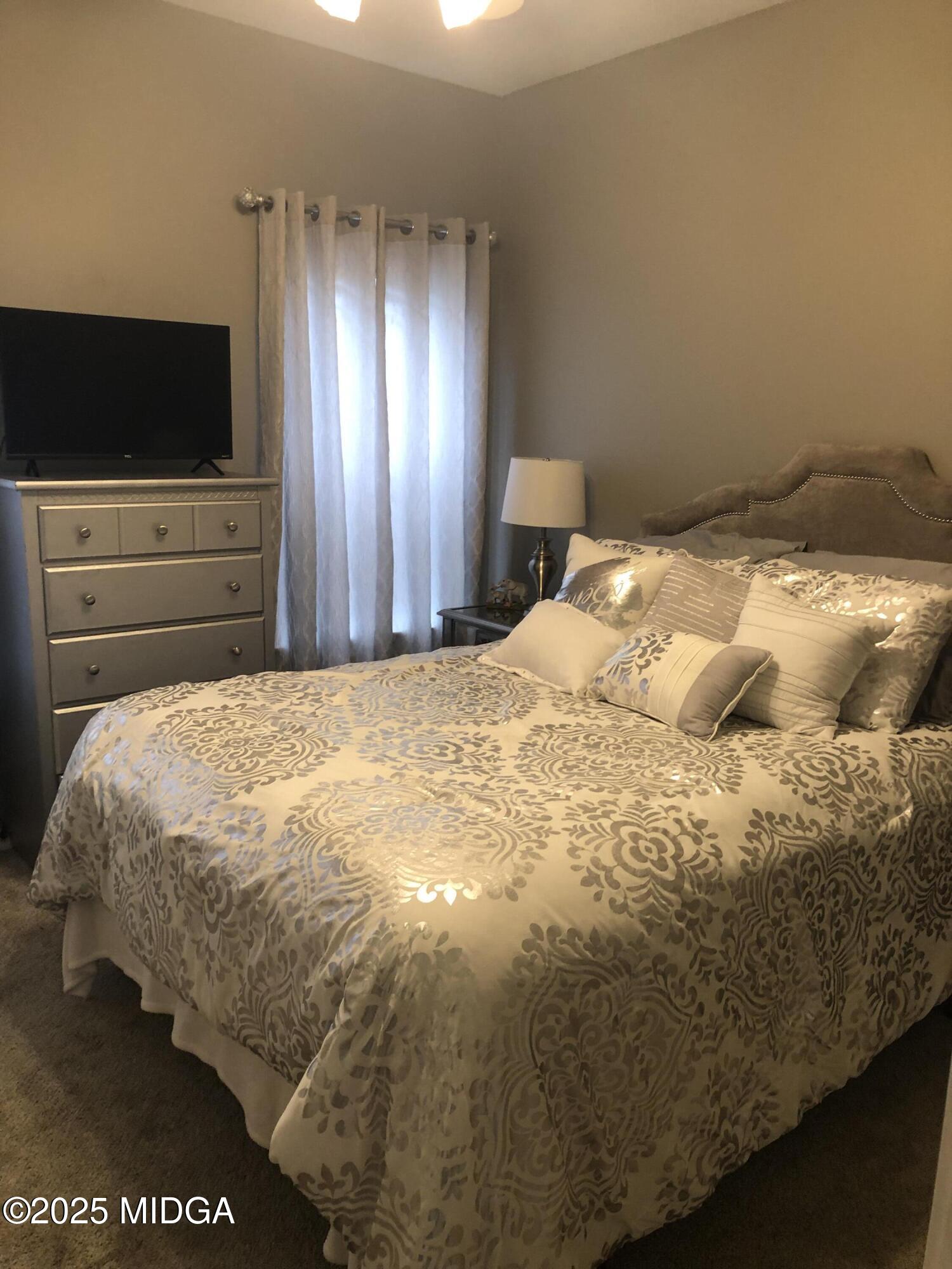 630 Millrun Court Macon, GA 31210 - Photo 19 of 23 a large bed sitting in a bedroom next to a window