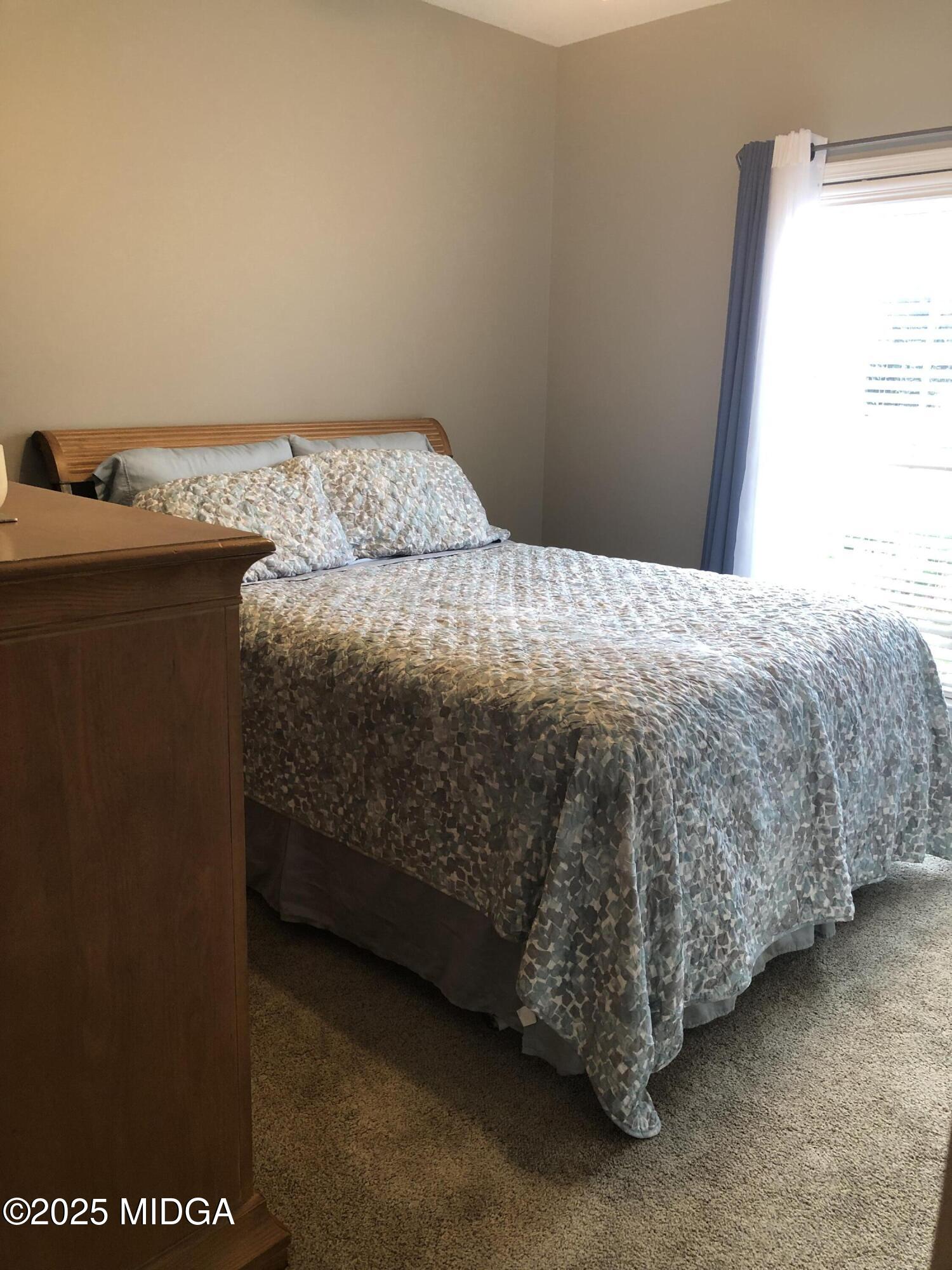 630 Millrun Court Macon, GA 31210 - Photo 20 of 23 a bedroom with a bed and a window