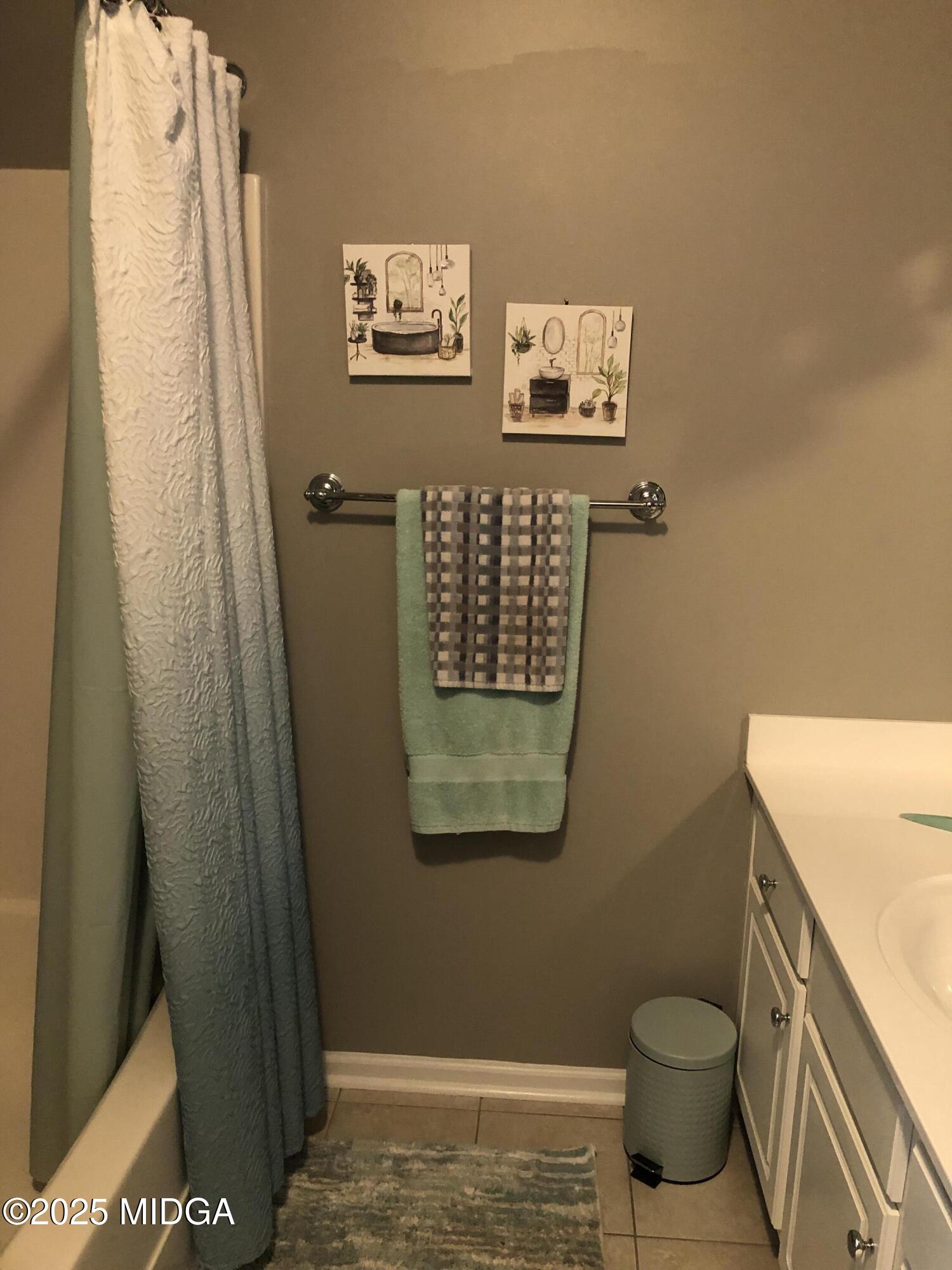 630 Millrun Court Macon, GA 31210 - Photo 22 of 23 a bathroom with a toilet and a shower curtain