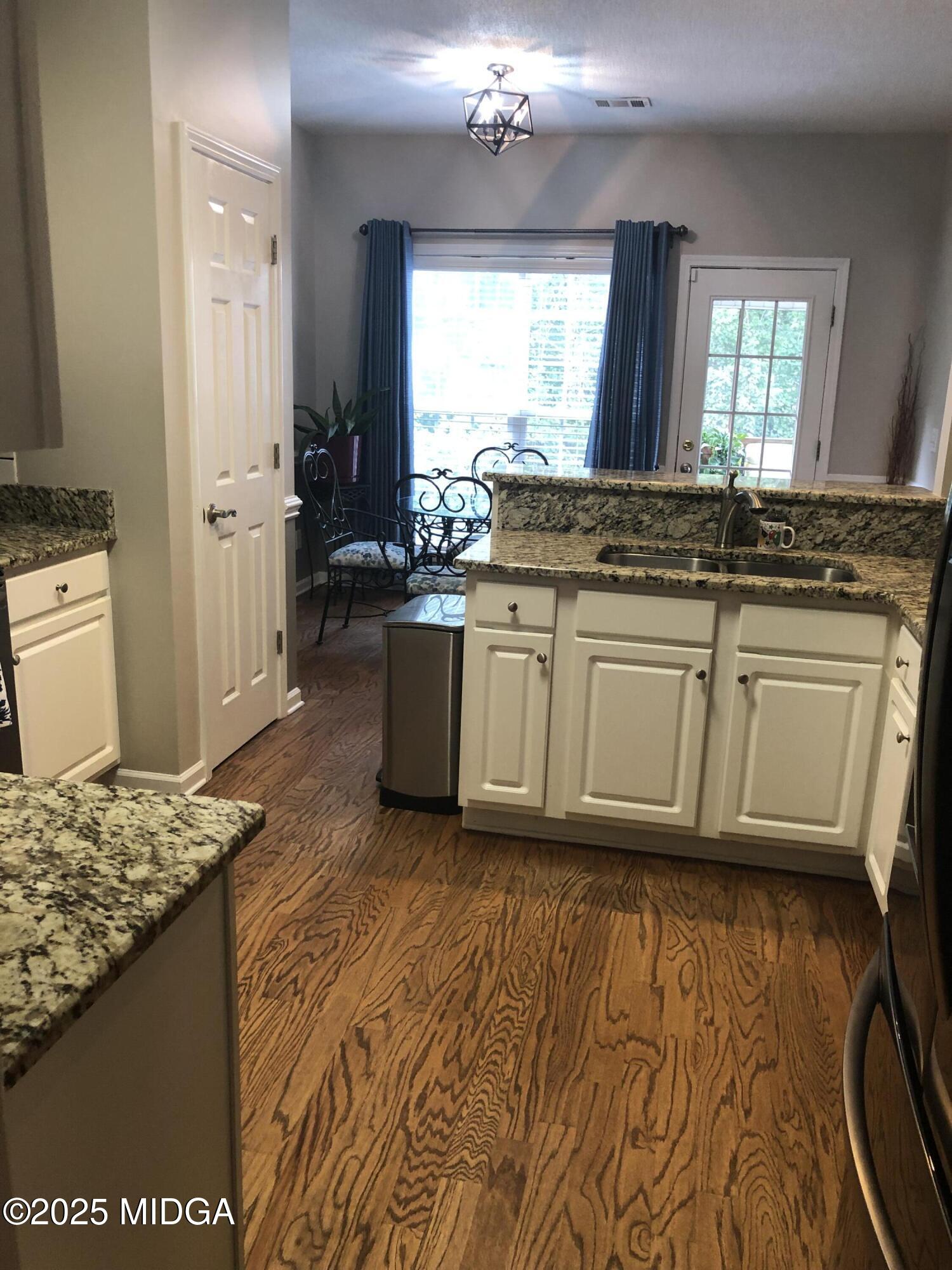 630 Millrun Court Macon, GA 31210 - Photo 23 of 23 a bathroom with a granite countertop sink and a mirror