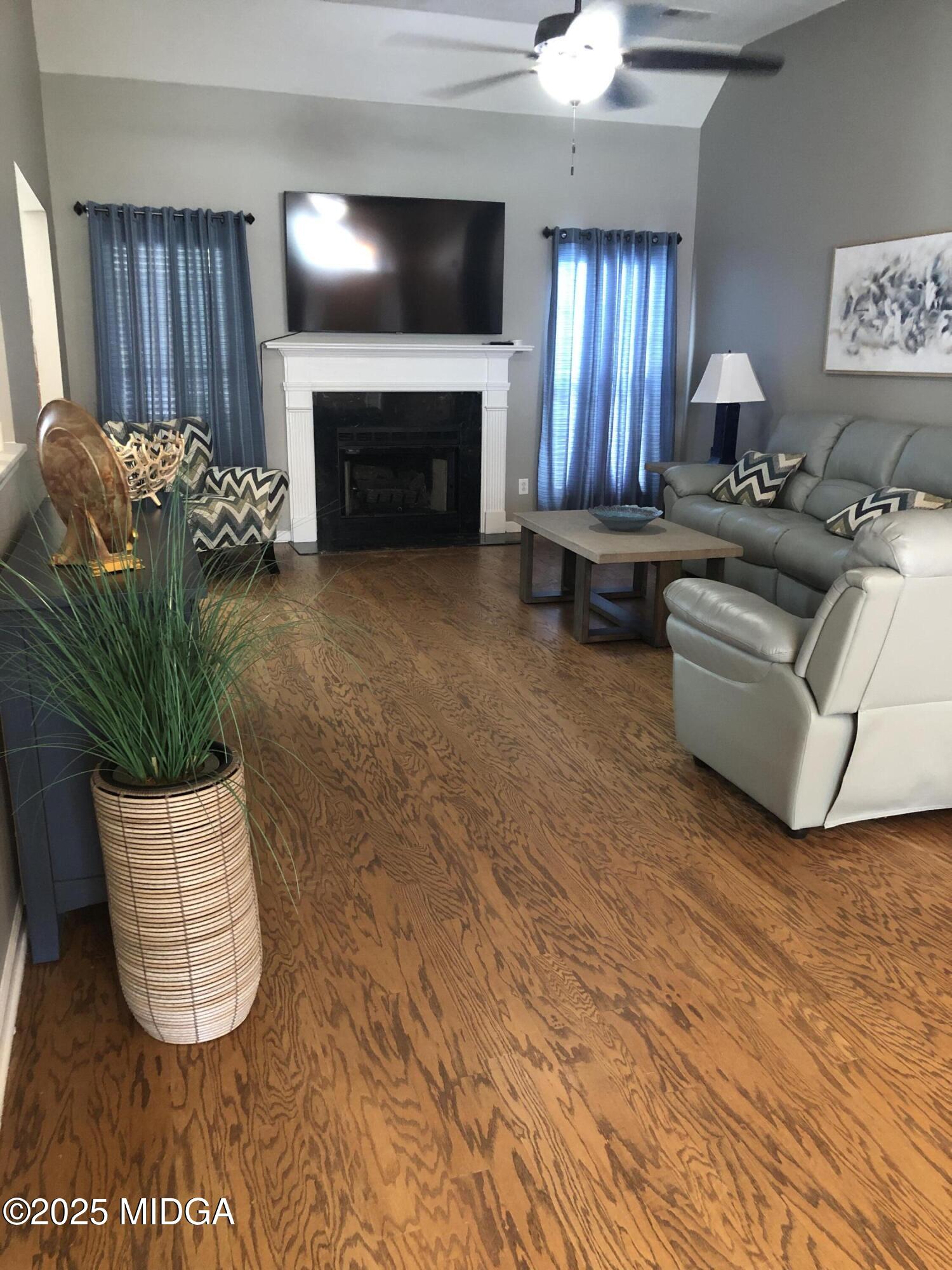 630 Millrun Court Macon, GA 31210 - Photo 5 of 23 a living room with furniture and a fireplace