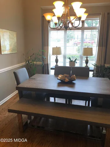 a living room with furniture wooden floor and a large window