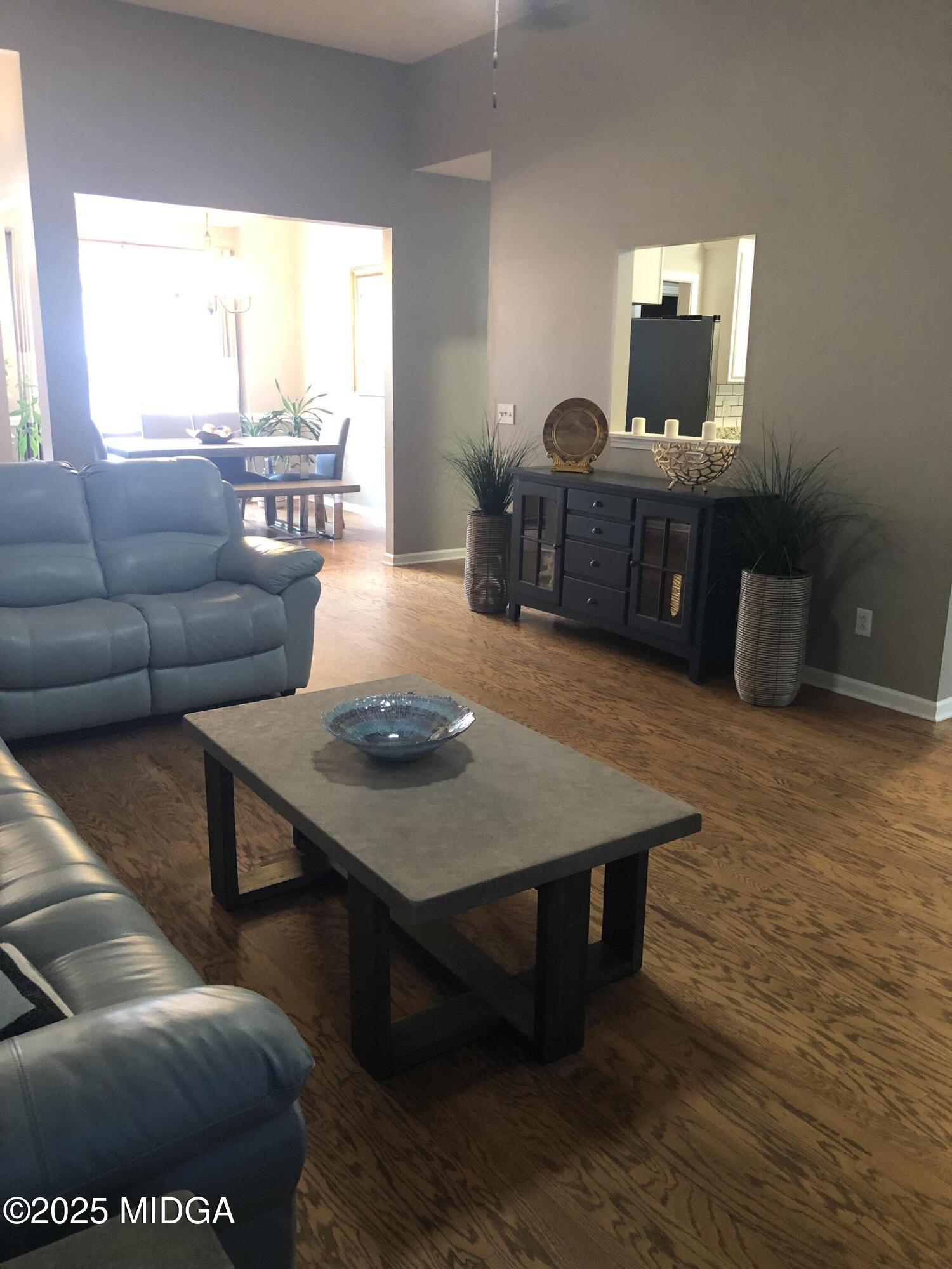 630 Millrun Court Macon, GA 31210 - Photo 7 of 23 a living room with furniture a large window and a flat screen tv