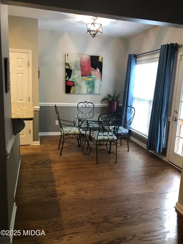 a view of a dining room with furniture and a window
