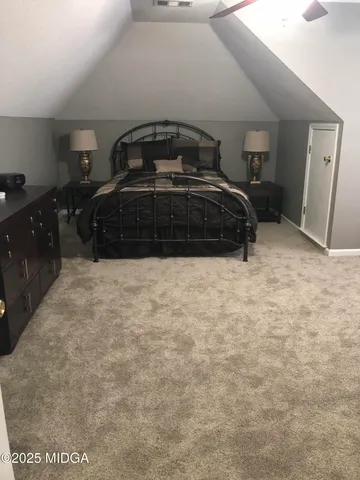 a bedroom with a bed and a car parked