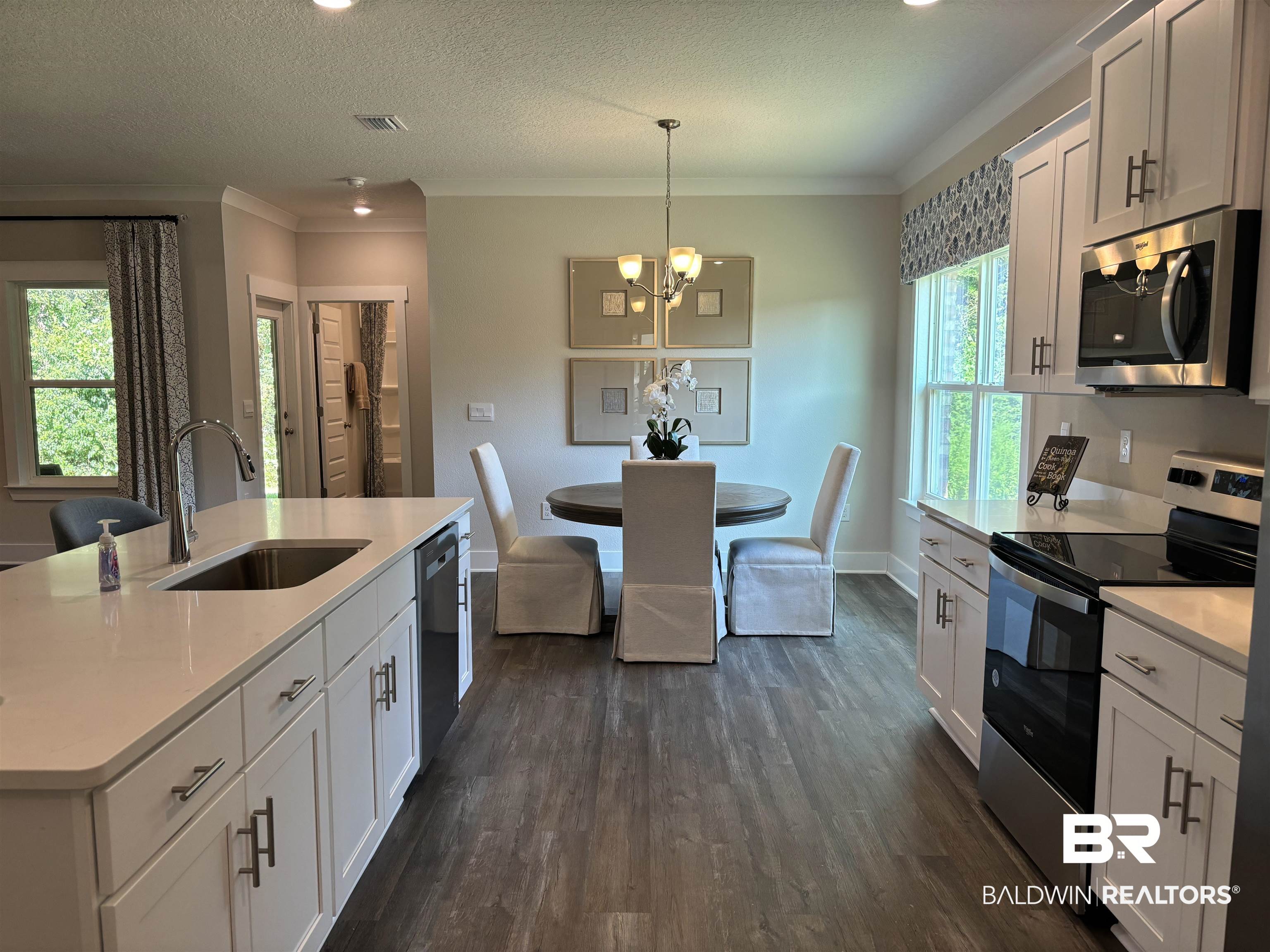370 Barndling Street Fairhope, AL 36532 - Photo 12 of 30 Kitchen featuring sink, white cabinetry, appliances with stainless steel finishes, and dark hardwood / wood-style floors