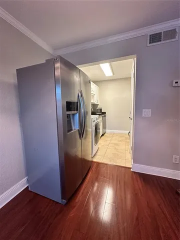 a view of empty room with wooden floor