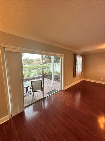 a view of room with window and wooden floor