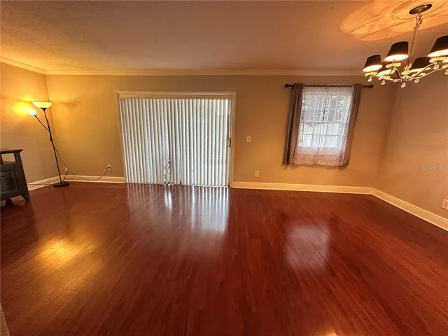 a view of a livingroom with wooden floor and a window