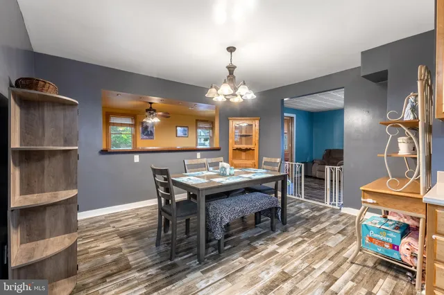 a view of a dining room with furniture and a chandelier