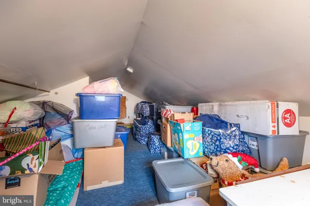 a utility room with stainless steel appliances lots of clutter