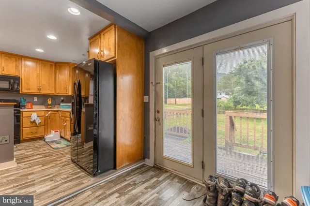 a view of a hallway with wooden floor and windows