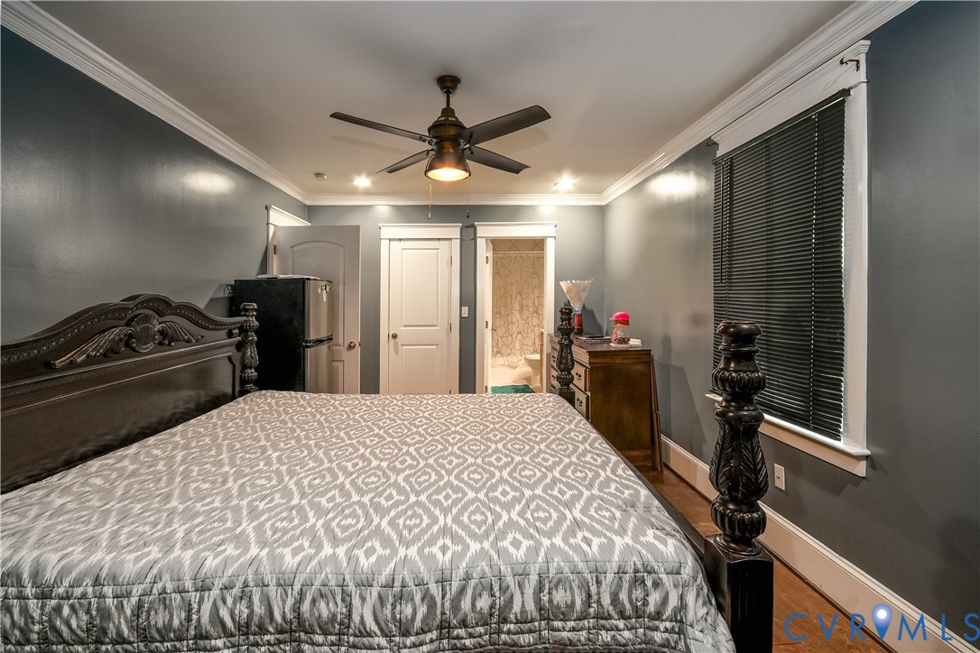 4903 Castlewood Road Richmond, VA 23234 - Photo 16 of 34 a bedroom with a bed and a chandelier