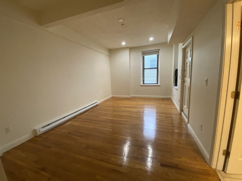 1008 Bennington Street, Unit 4A Boston, MA 02128 - Photo 6 of 9 a view of hallway with wooden floor