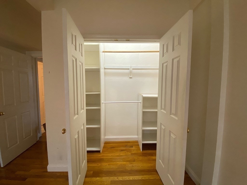 1008 Bennington Street, Unit 4A Boston, MA 02128 - Photo 7 of 9 a view of a bathroom with wooden floor and a window