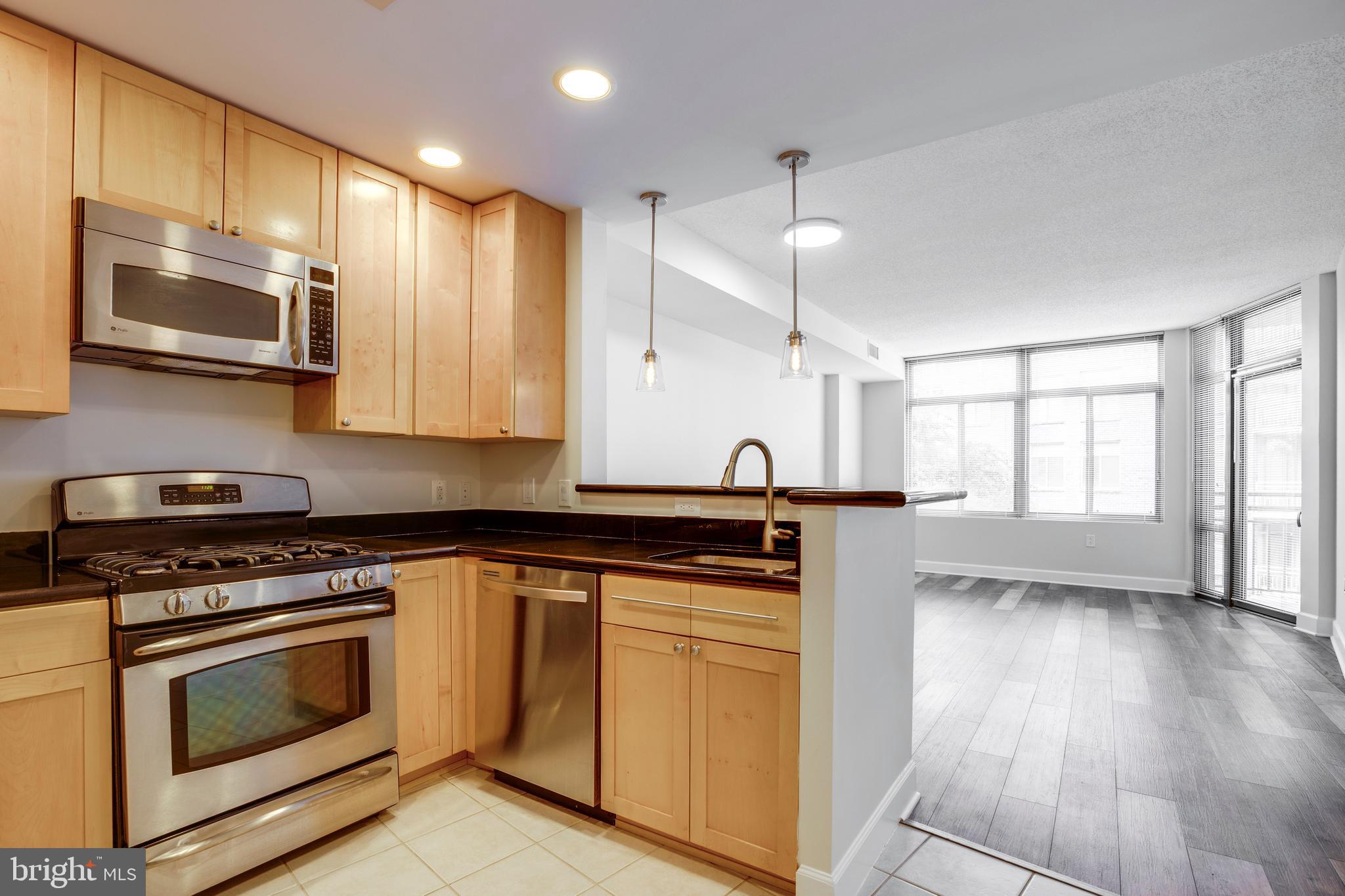 3600 South Glebe Road, Unit 427W Arlington, VA 22202 - Photo 1 of 49 a kitchen with stainless steel appliances a stove a sink and a microwave