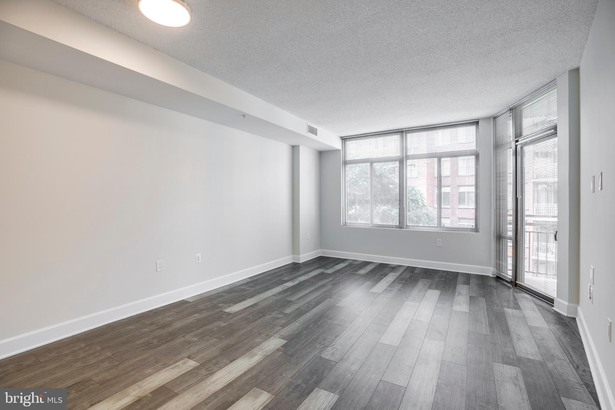 3600 South Glebe Road, Unit 427W Arlington, VA 22202 - Photo 11 of 49 a view of an empty room with wooden floor and a window