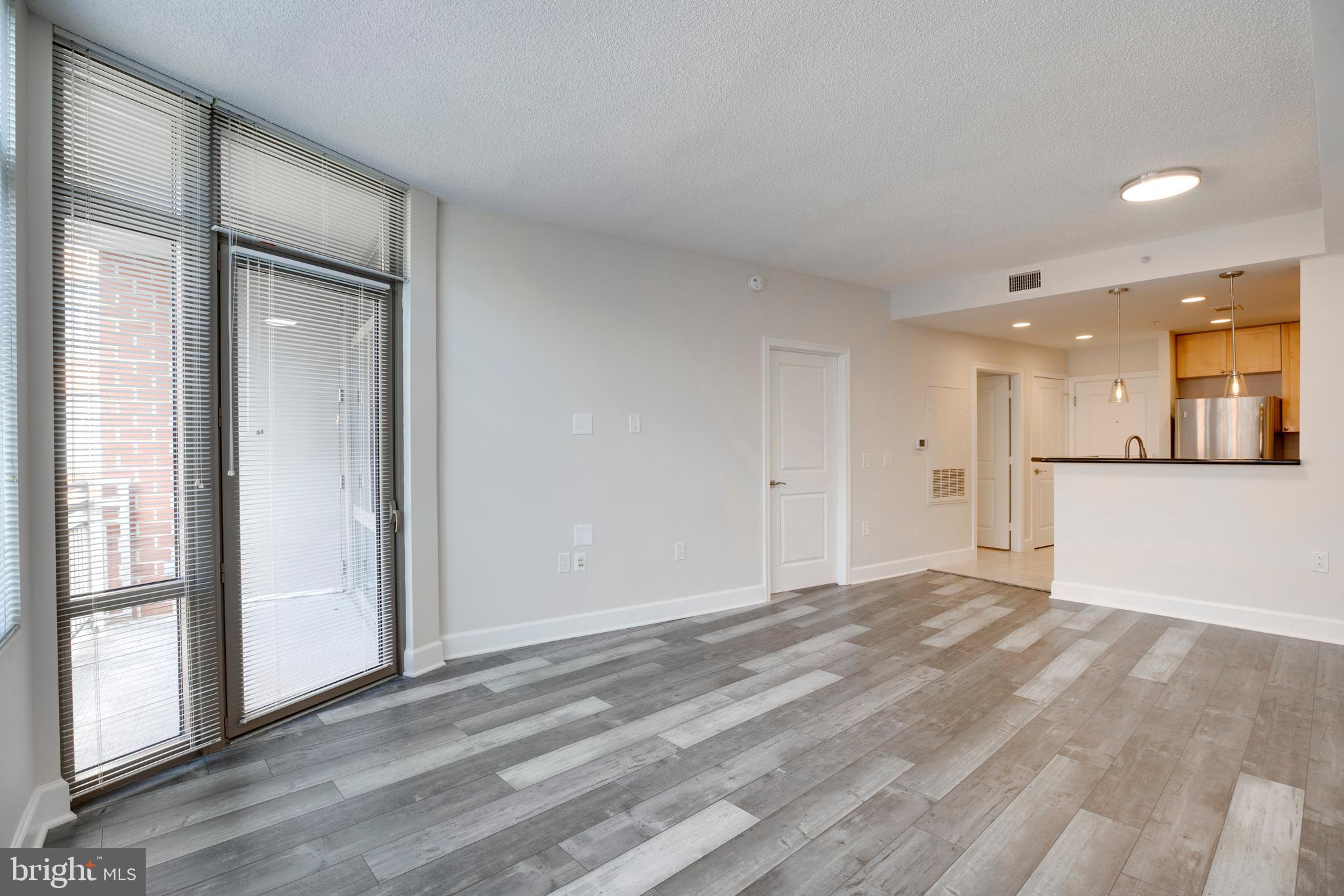 3600 South Glebe Road, Unit 427W Arlington, VA 22202 - Photo 12 of 49 a view of an empty room with wooden floor and a window