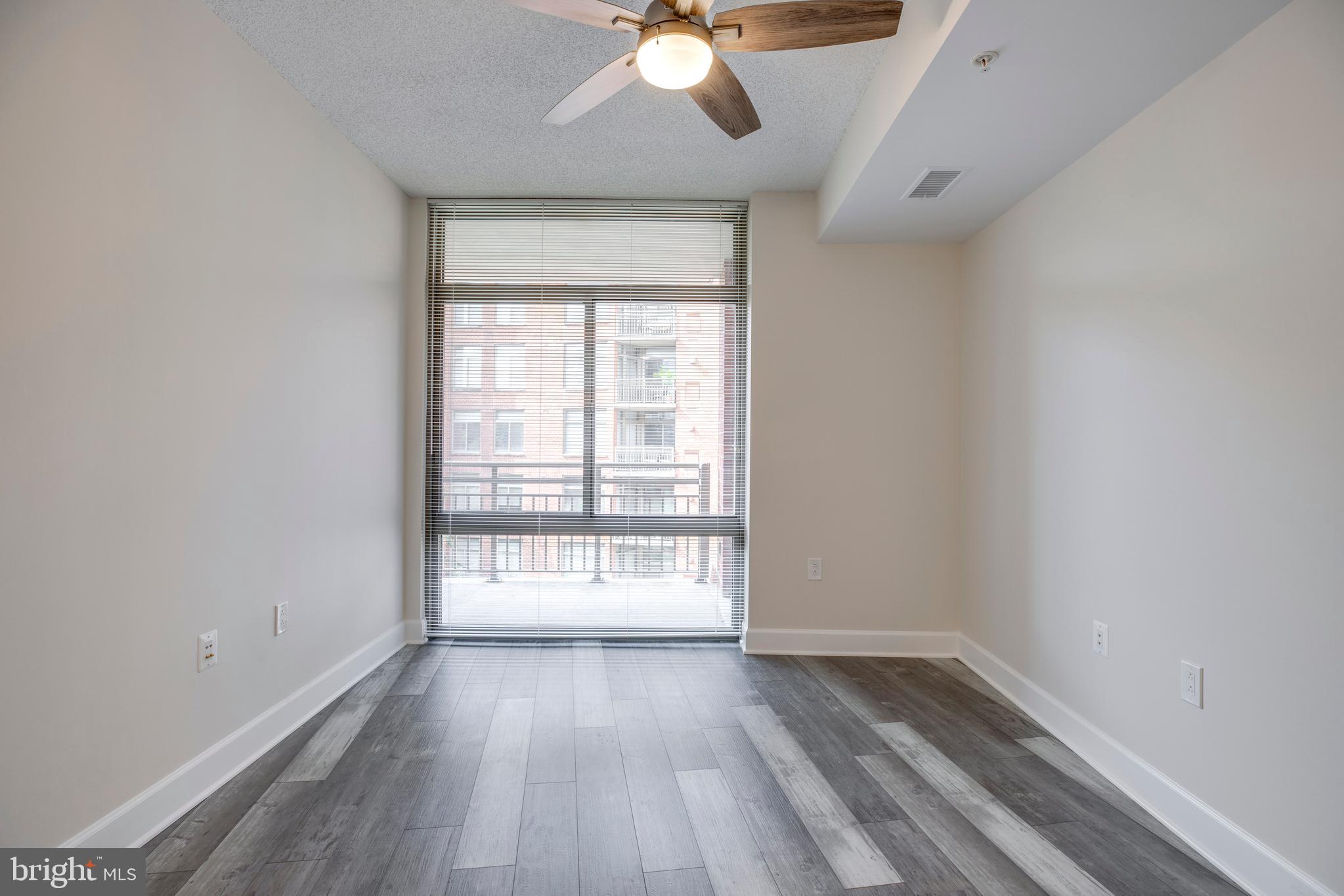 3600 South Glebe Road, Unit 427W Arlington, VA 22202 - Photo 20 of 49 wooden floor in an empty room with a window