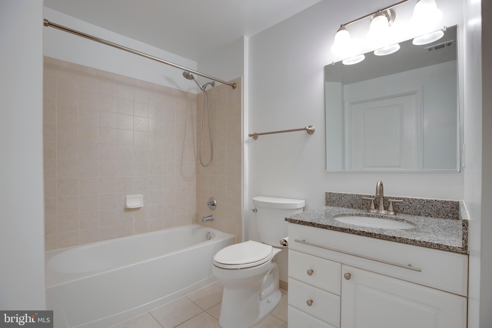 3600 South Glebe Road, Unit 427W Arlington, VA 22202 - Photo 21 of 49 a bathroom with a granite countertop sink a toilet and shower