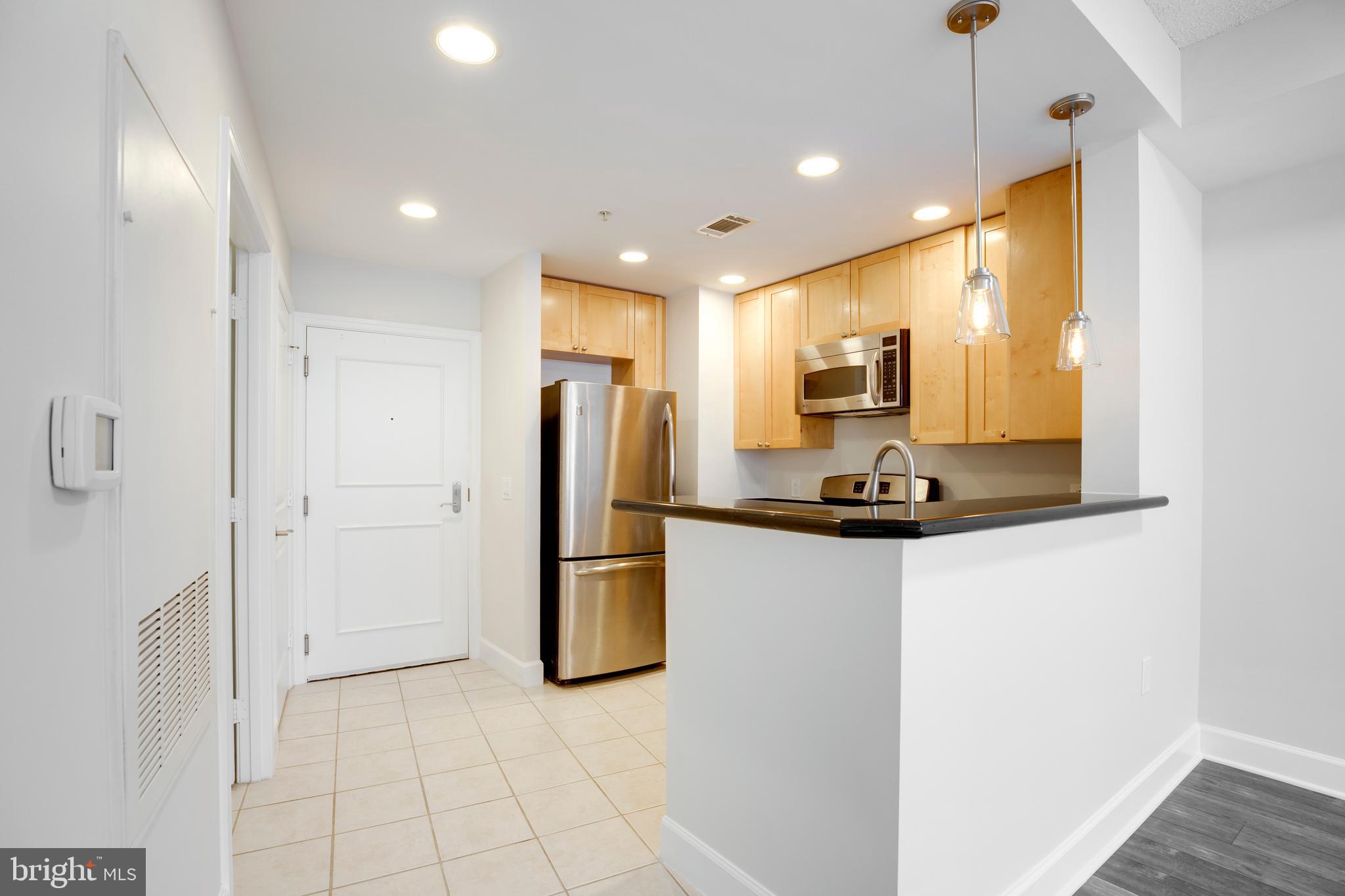 3600 South Glebe Road, Unit 427W Arlington, VA 22202 - Photo 3 of 49 a kitchen with stainless steel appliances a refrigerator and microwave