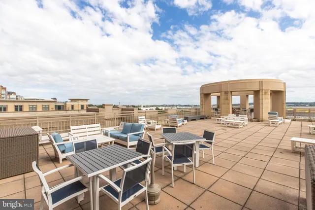 a view of a patio with dining table and chairs