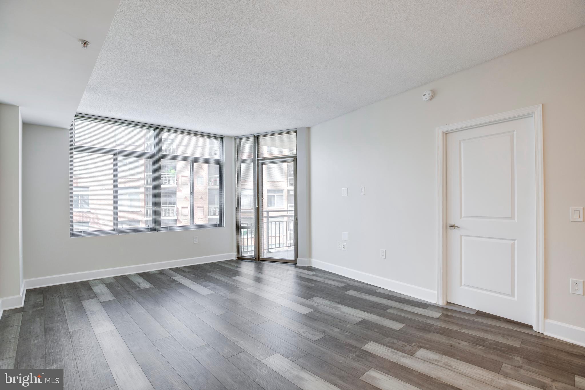 3600 South Glebe Road, Unit 427W Arlington, VA 22202 - Photo 9 of 49 a view of an empty room with wooden floor and a window