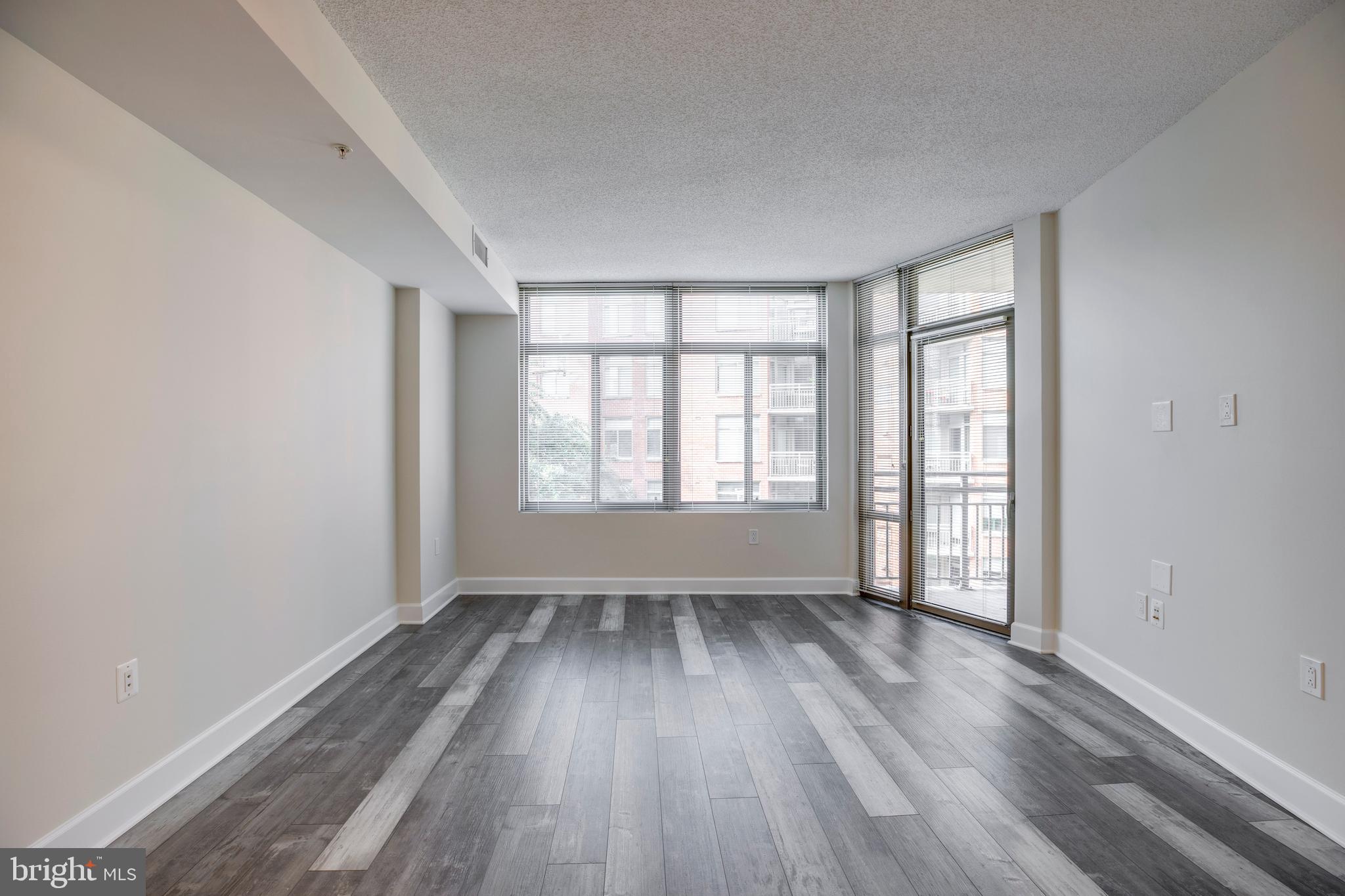 3600 South Glebe Road, Unit 427W Arlington, VA 22202 - Photo 10 of 49 wooden floor in an empty room with a window
