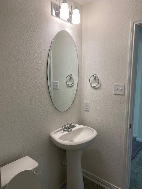 727 Hardwood Grove Houston, TX 77090 - Photo 15 of 26 a bathroom with a sink a mirror and a toilet