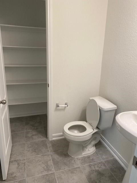 727 Hardwood Grove Houston, TX 77090 - Photo 16 of 26 a white toilet sitting next to a sink