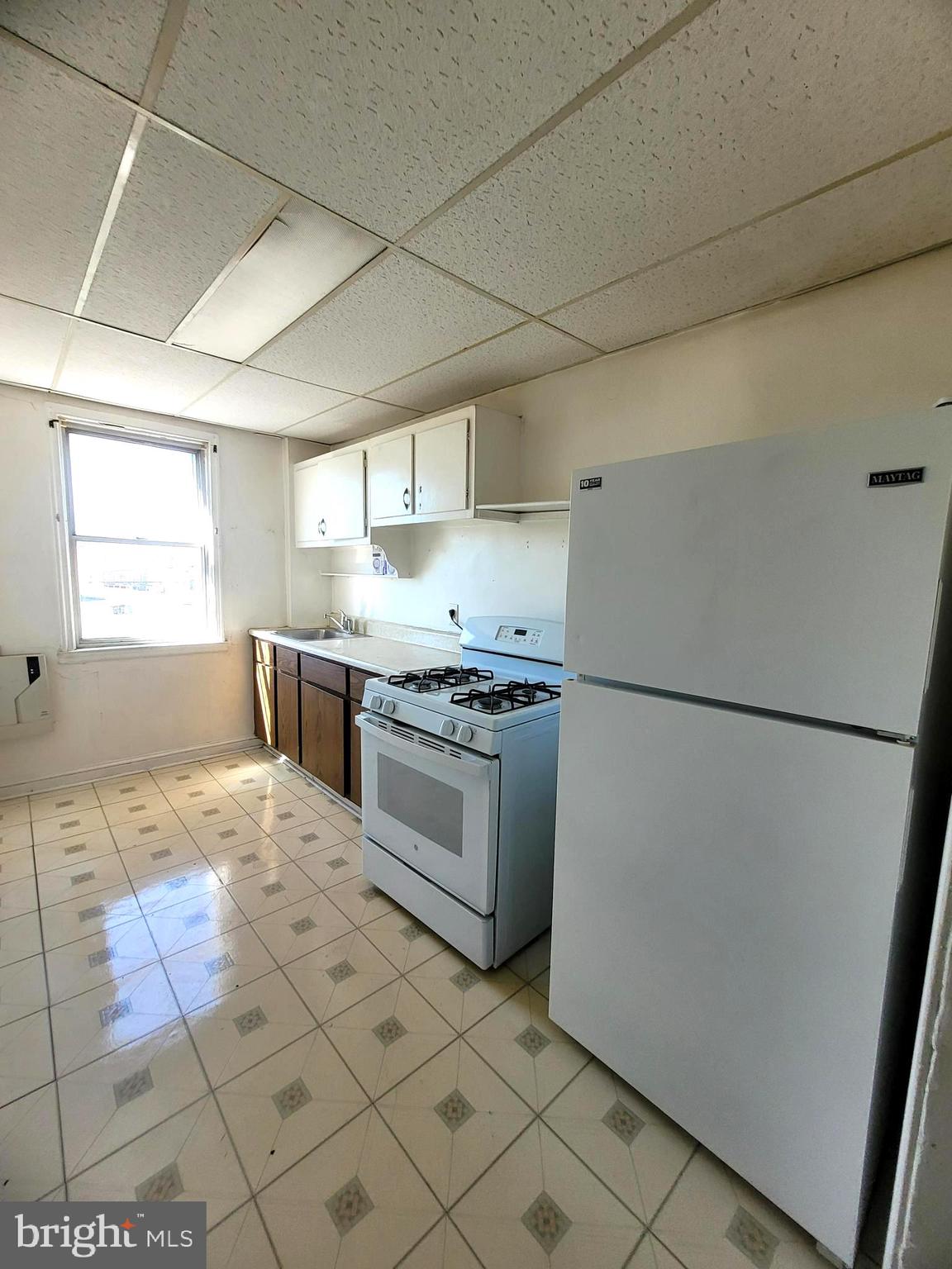 2930 Sollers Point Road Dundalk, MD 21222 - Photo 7 of 12 a kitchen with a refrigerator sink and cabinets