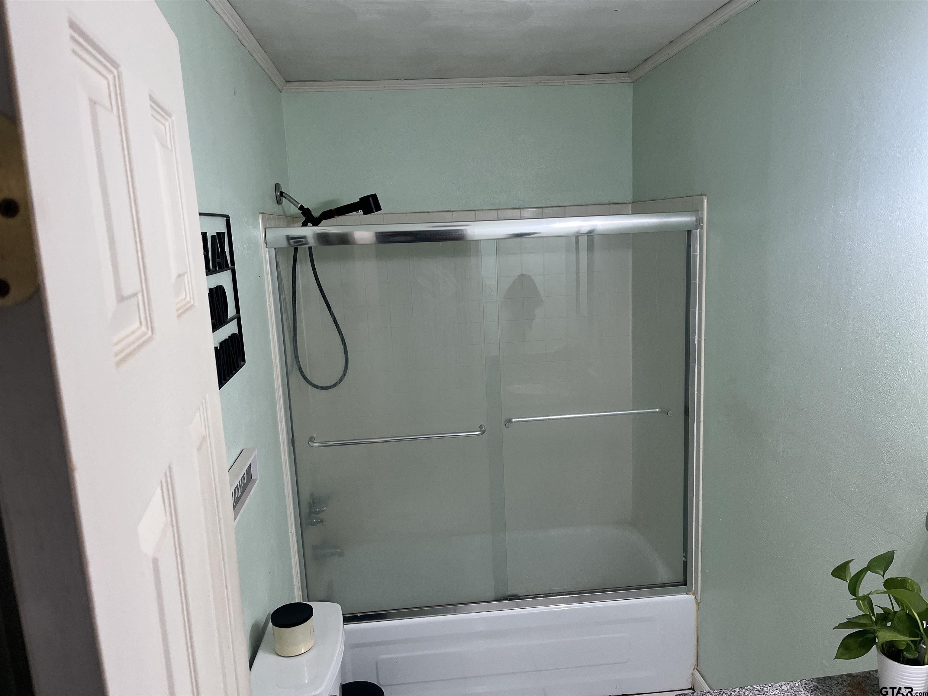 407 Fulton Street Pittsburg, TX 75686 - Photo 16 of 30 a bathroom with a shower