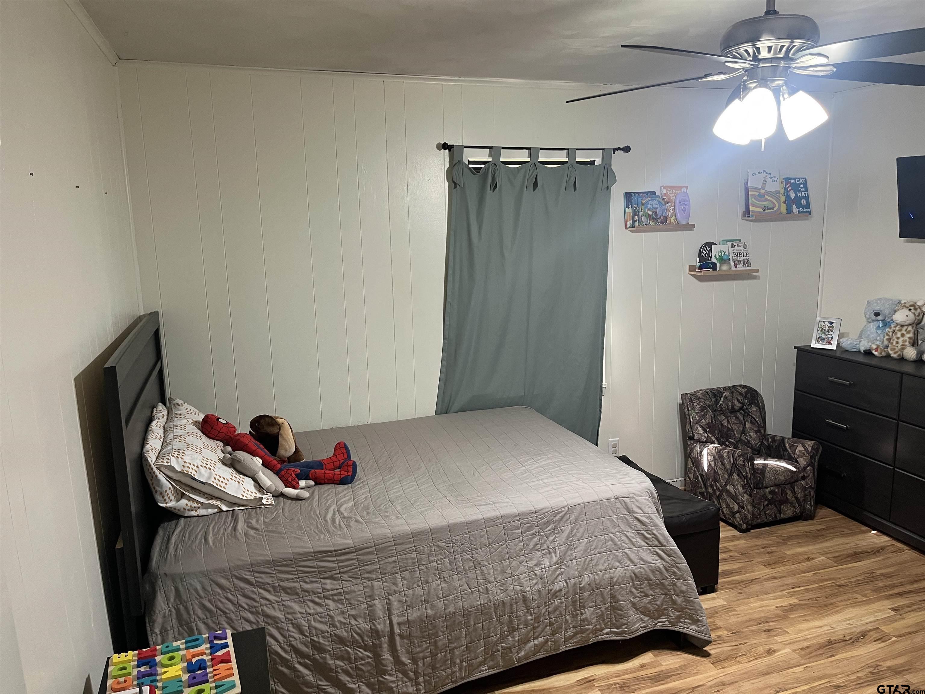 407 Fulton Street Pittsburg, TX 75686 - Photo 19 of 30 a bedroom with a bed and a dresser