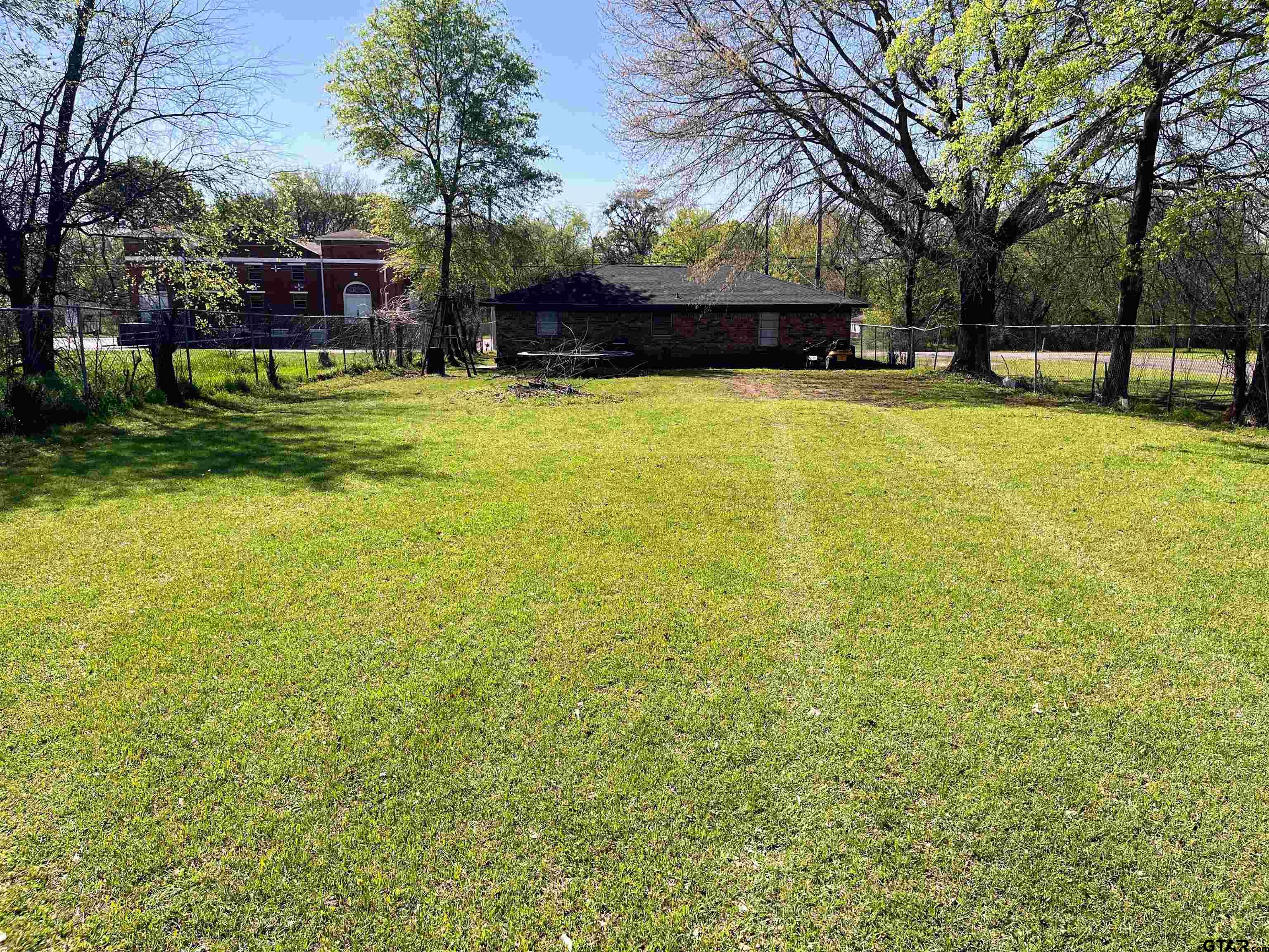 407 Fulton Street Pittsburg, TX 75686 - Photo 2 of 30 a view of swimming pool with outdoor seating and trees