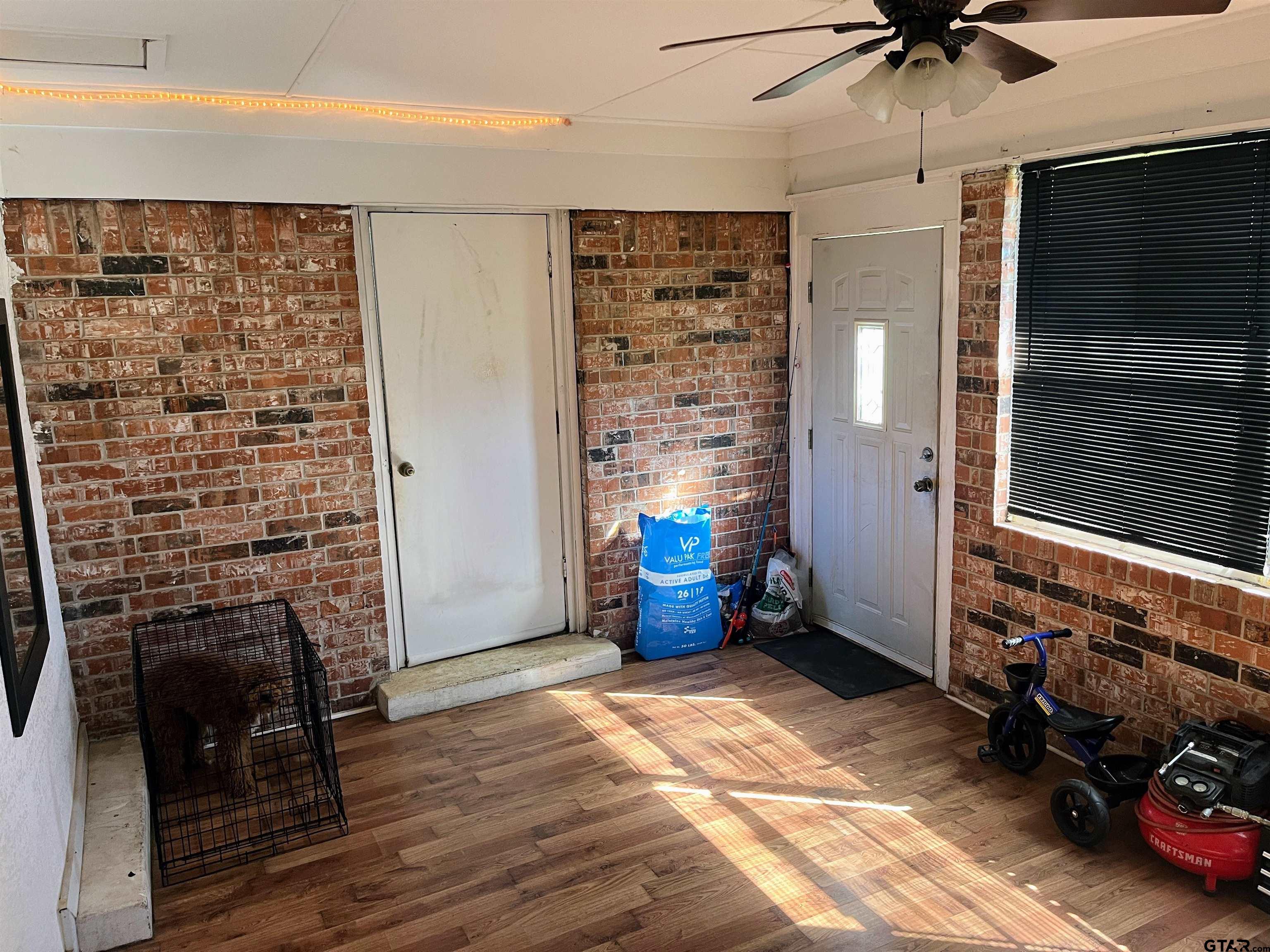 407 Fulton Street Pittsburg, TX 75686 - Photo 24 of 30 a view of livingroom with hardwood floor and a ceiling fan