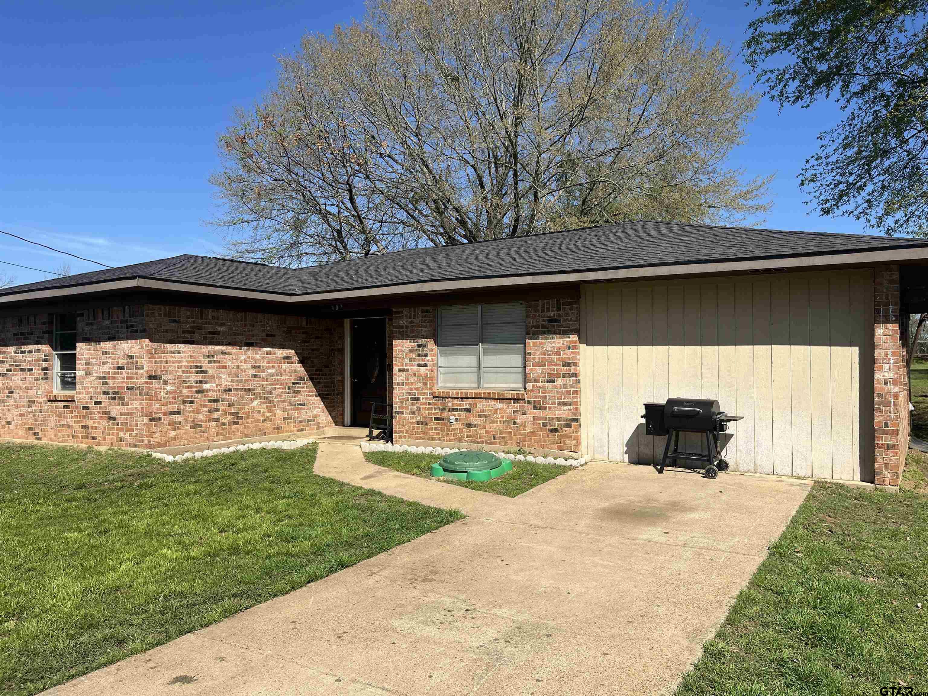 407 Fulton Street Pittsburg, TX 75686 - Photo 26 of 30 a view of a house with a yard