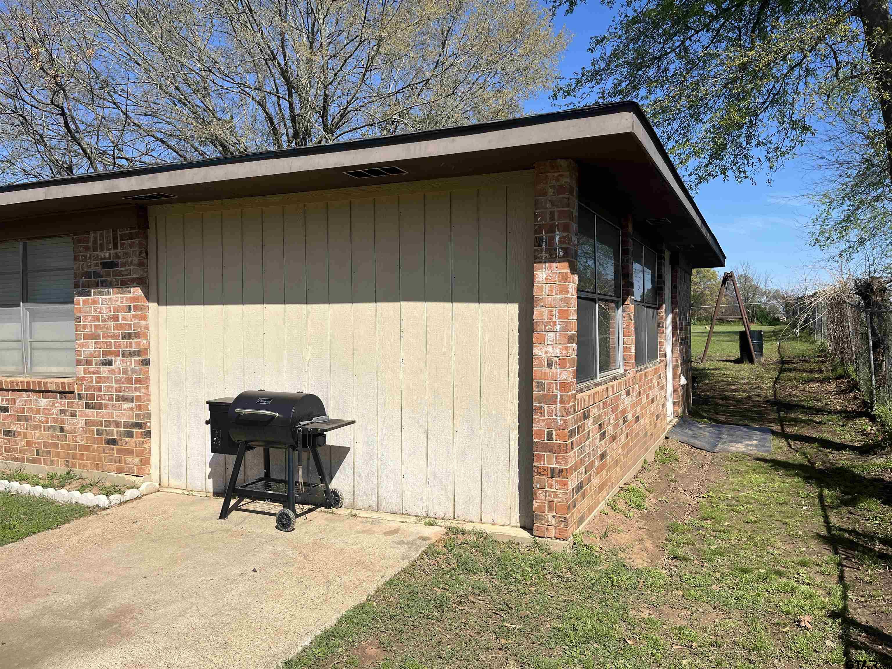 407 Fulton Street Pittsburg, TX 75686 - Photo 27 of 30 a view of backyard with barbeque grill and outdoor seating