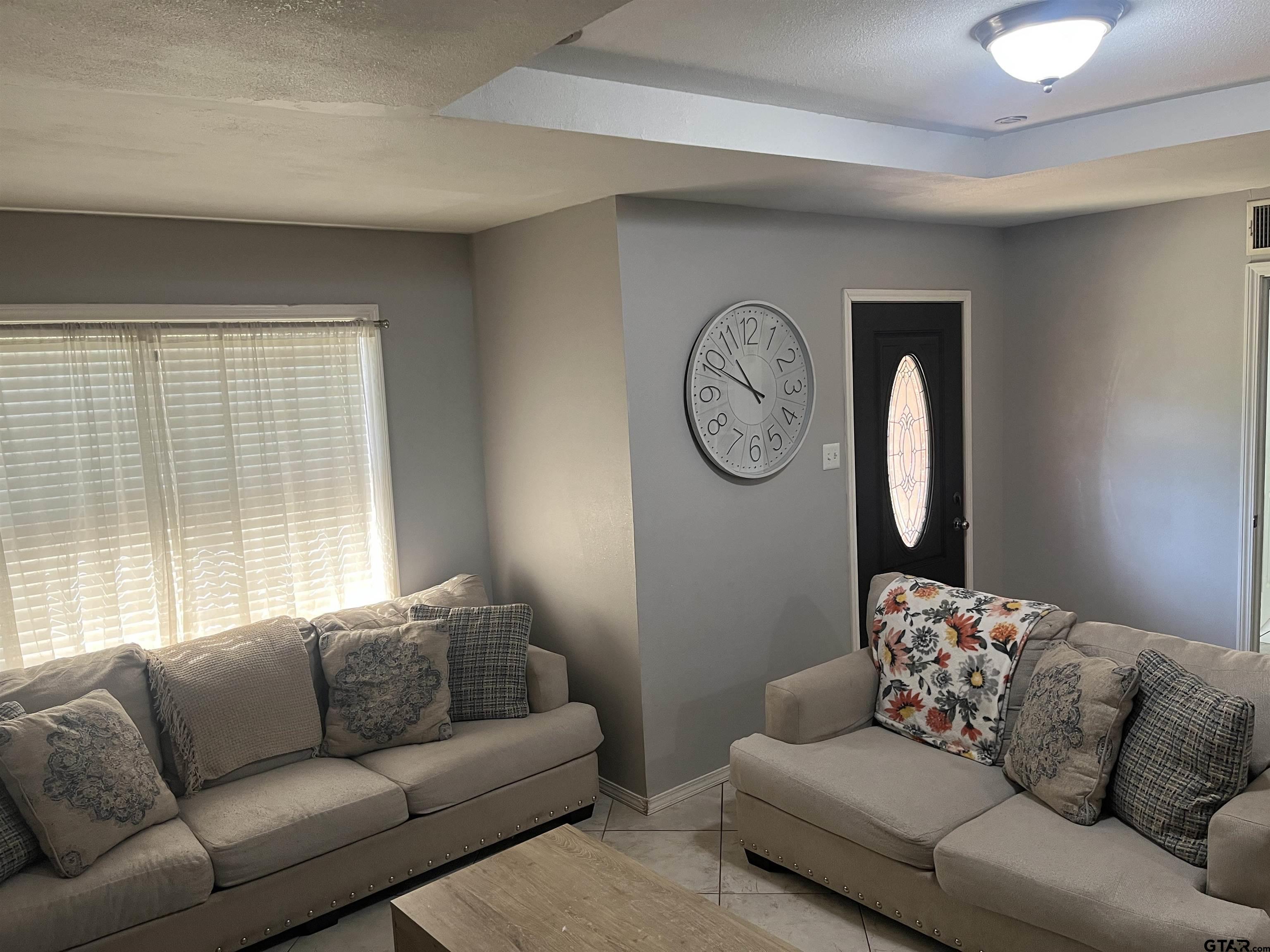 407 Fulton Street Pittsburg, TX 75686 - Photo 3 of 30 a living room with furniture and a large window