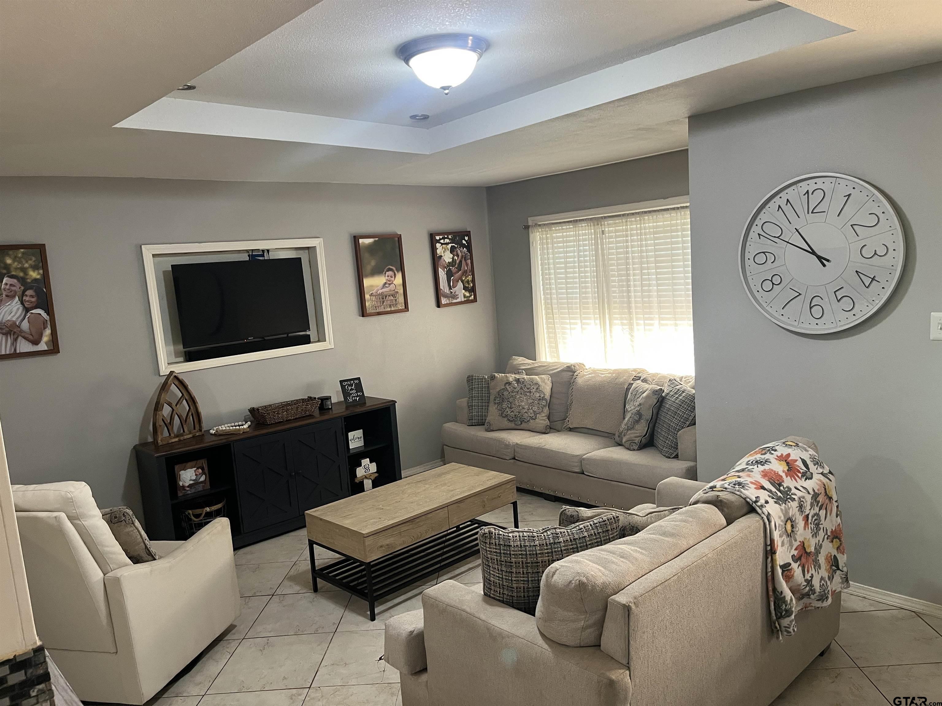 407 Fulton Street Pittsburg, TX 75686 - Photo 4 of 30 a living room with furniture and a flat screen tv