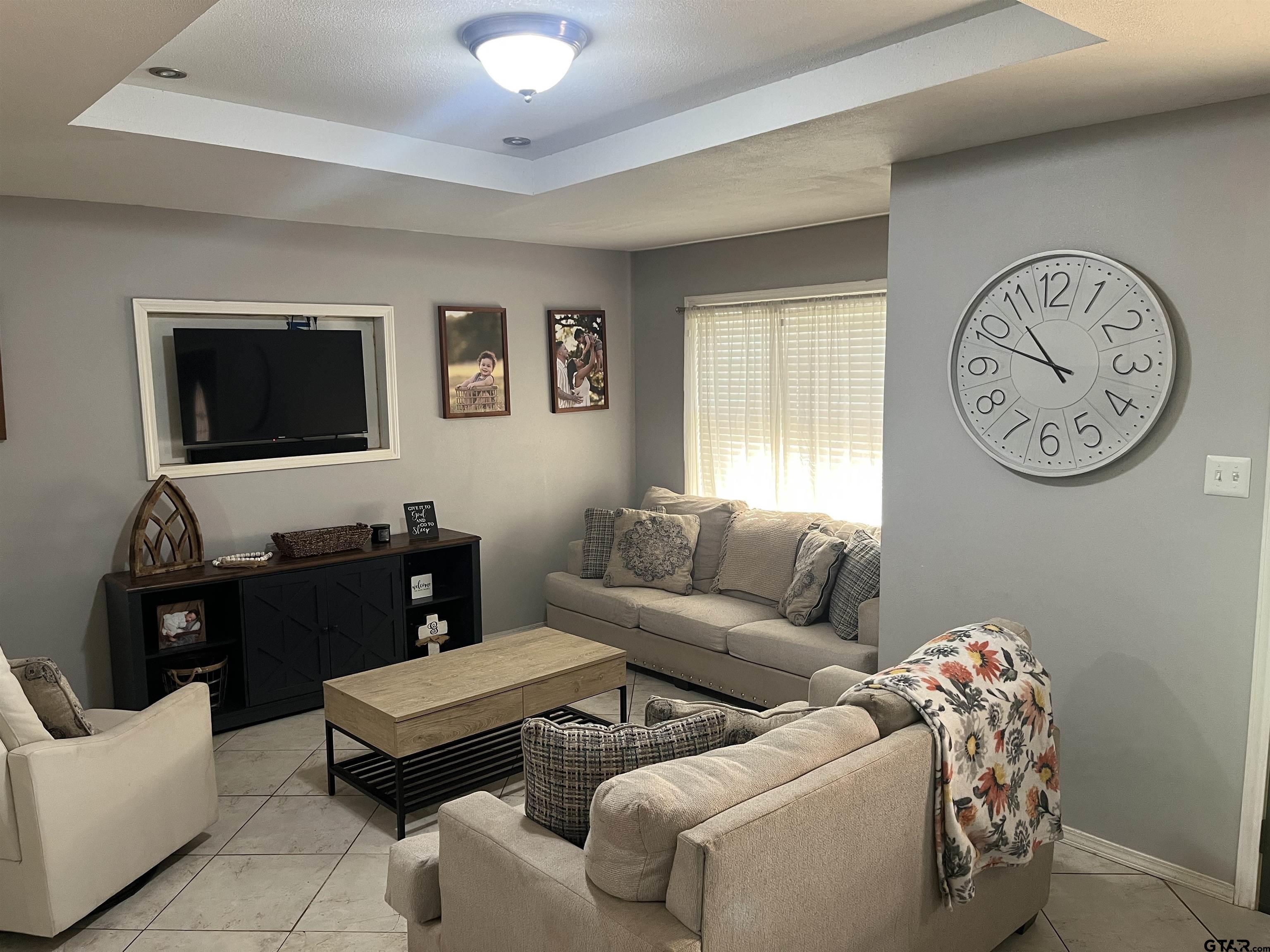 407 Fulton Street Pittsburg, TX 75686 - Photo 6 of 30 a living room with furniture a window and a flat screen tv