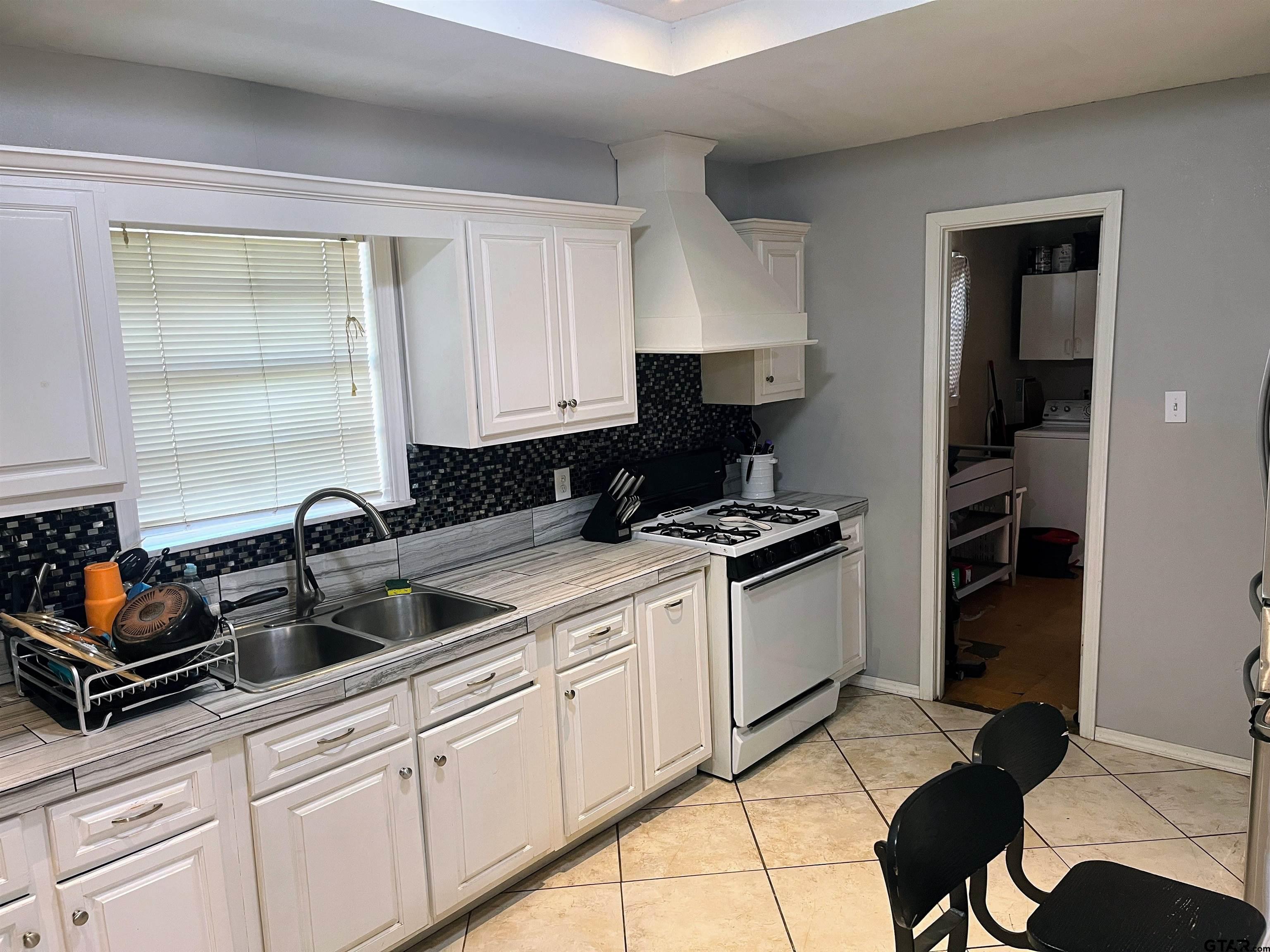 407 Fulton Street Pittsburg, TX 75686 - Photo 8 of 30 a kitchen with a sink and cabinets