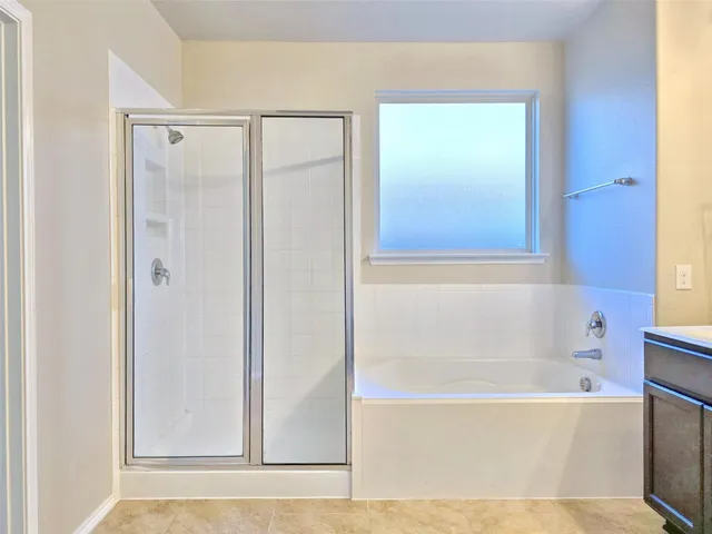 a bathroom with a bathtub and a shower