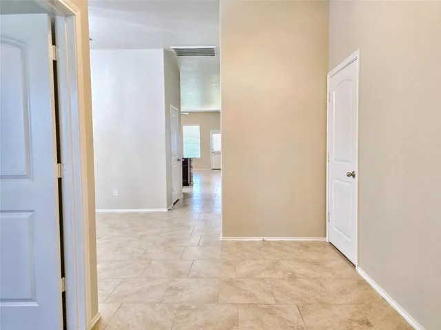 an empty room with cabinet and mirror
