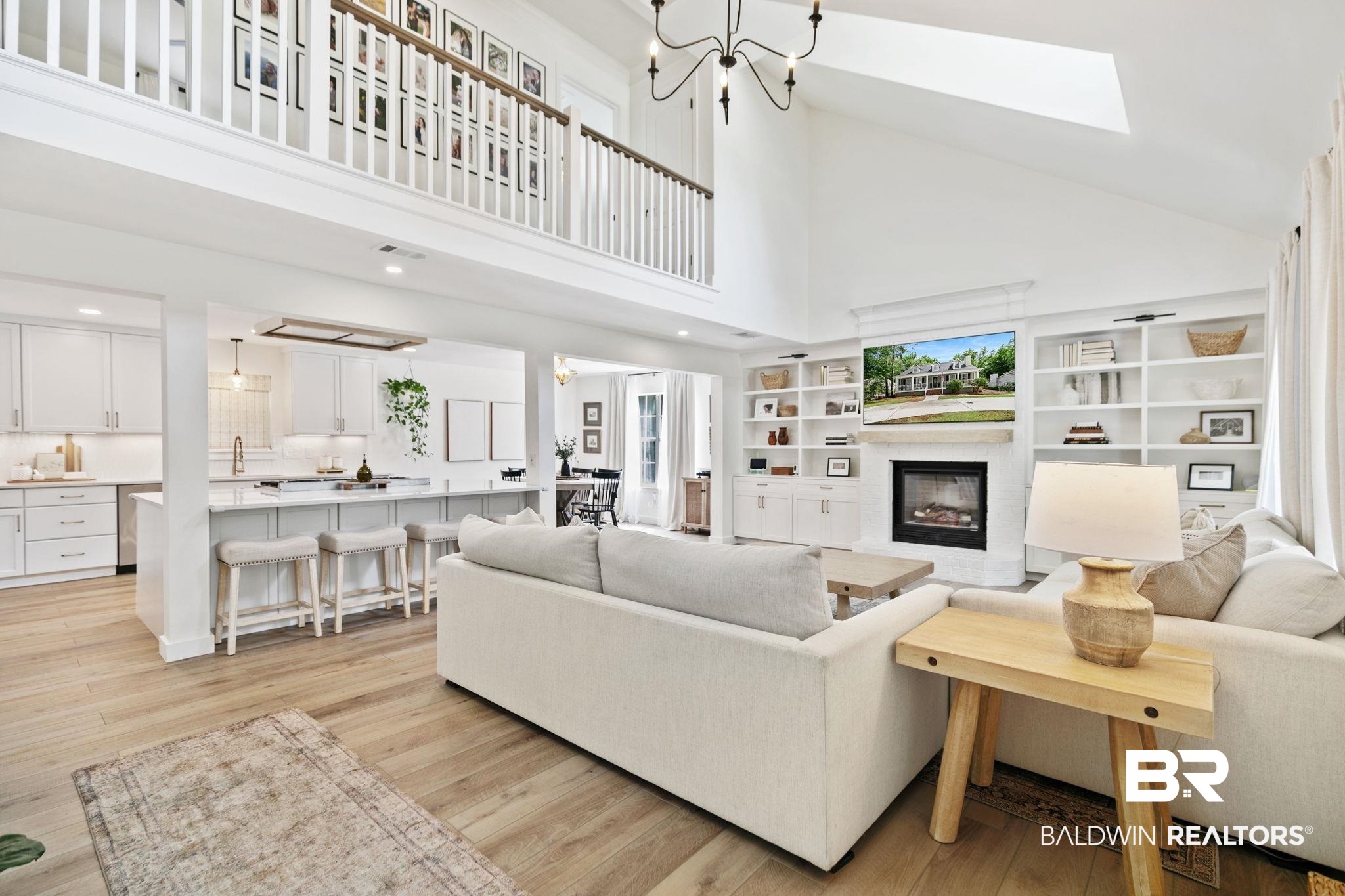 342 Ridgewood Drive Daphne, AL 36526 - Photo 32 of 36 Living room featuring a fireplace, high vaulted ceiling, light hardwood / wood-style floors, and a skylight
